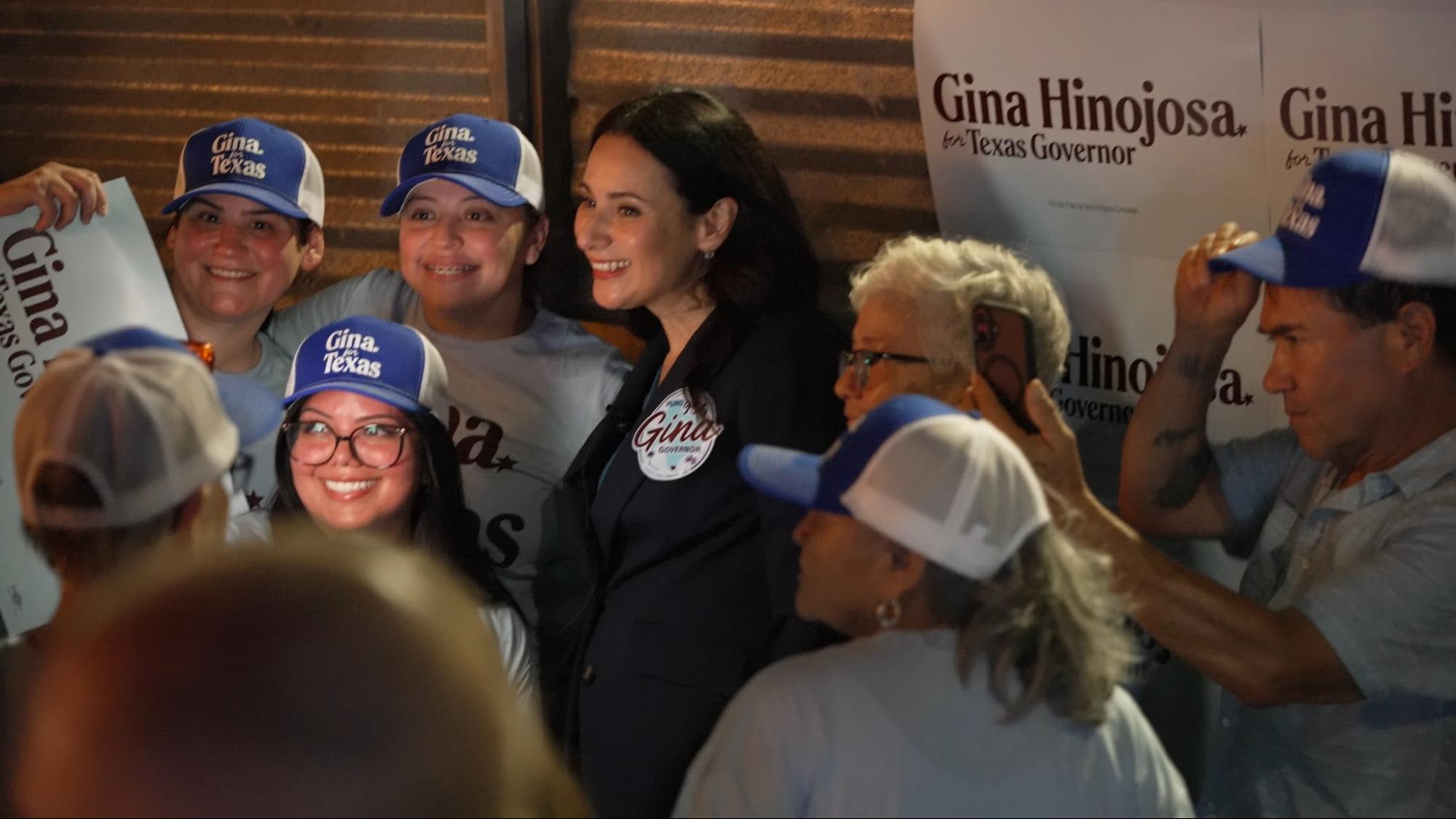 Gina taking pictures with supporters at an event