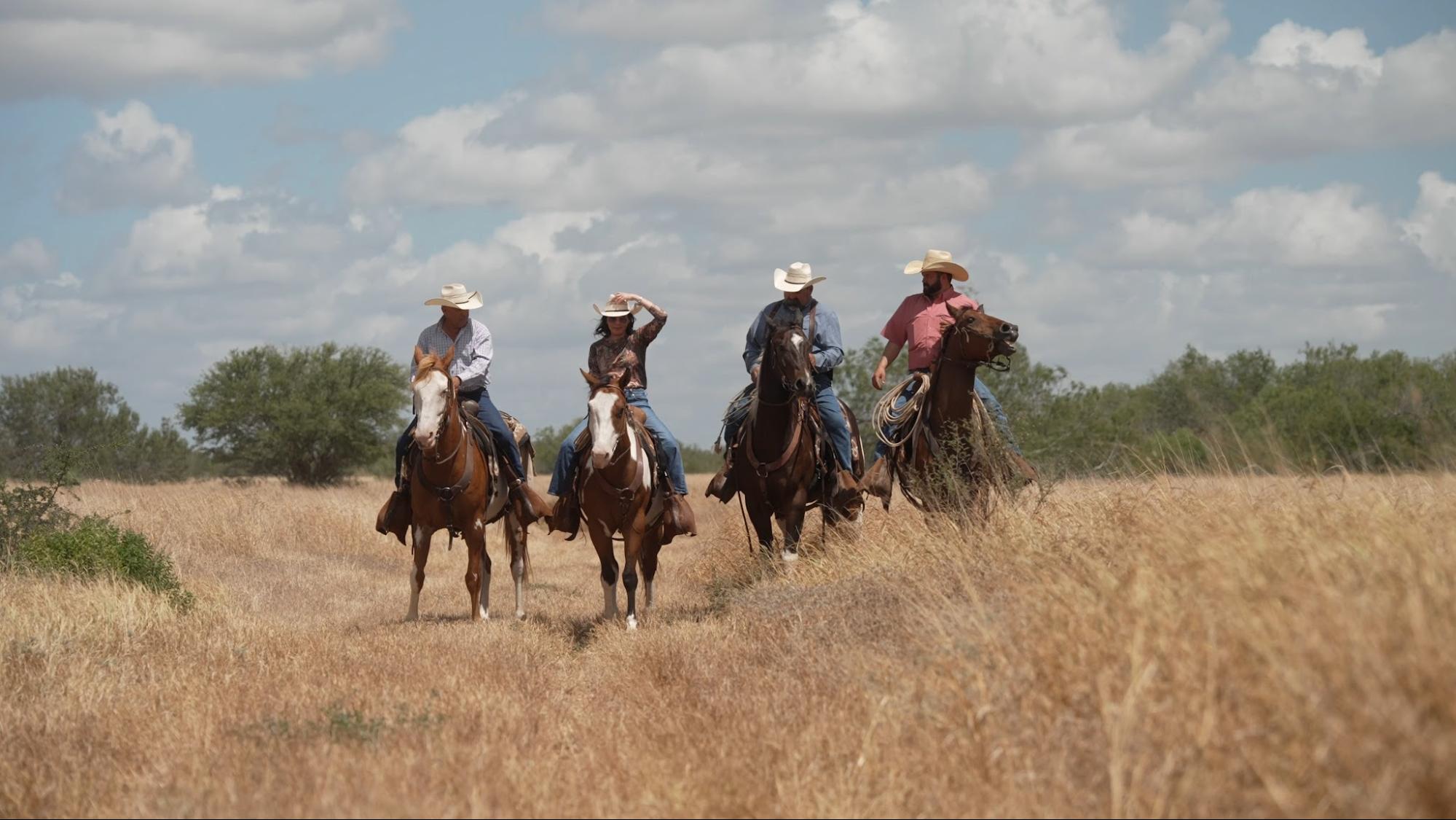 Gina riding a horse with community members